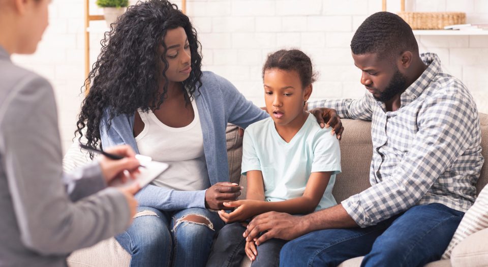 Parenting challenges and solutions for families facing bipolar disorder An african american family speaks with a counselor about an bipolar disorder