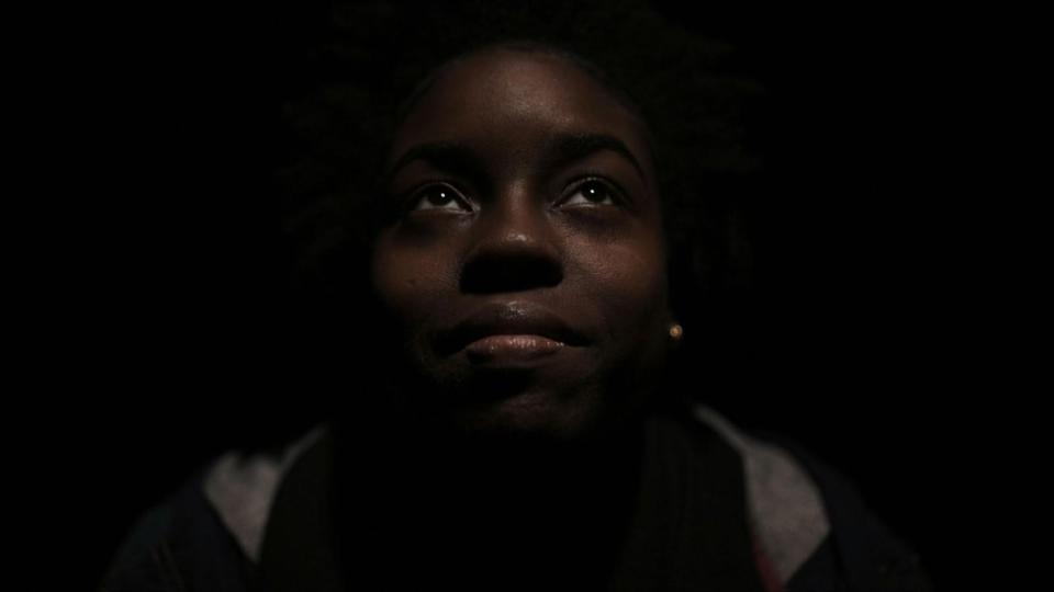 Invisible in plain sight: black teens in mental health crisis throughout phoenix A black teen looking upward in low light, symbolizing hope amid mental health challenges and housing instability in phoenix for an article about invisible in plain sight: black teens in mental health crisis throughout phoenix.