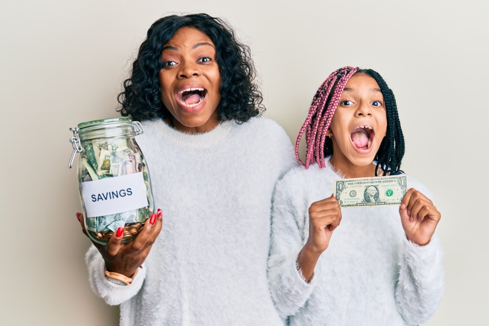 Top money saving tactics for families in 2025 Beautiful african american mother and daughter holding jar with savings and 1 dollar banknote celebrating crazy and amazed for success with open eyes screaming excited for an article top money saving tactics for families in 2025.