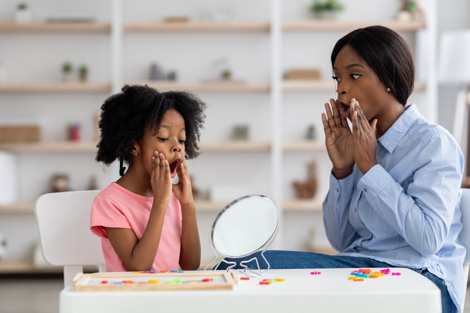 An african american speech therapist with her client speech therapy for kids: what parents should expect