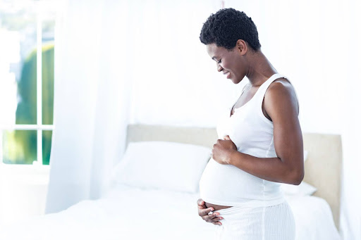 Can you get dermal fillers while pregnant? Are lip fillers safe during pregnancy, pregnant woman resting at home, safe beauty options while expecting for an article titled, "can you get dermal fillers while pregnant? "