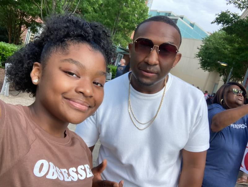 R&b singer denaron on music, fatherhood, and raising a young queen African american father and r&b singer denaron, and teenage daughter london, smiling at a public outdoor event. A heartwarming father’s day moment.