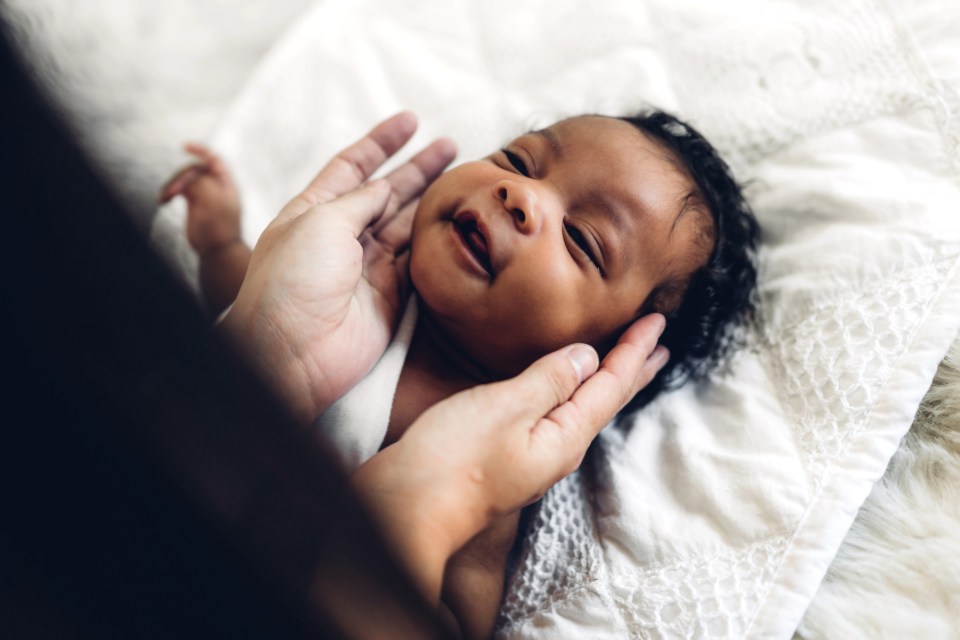 Find the perfect baby name and essential gear for new parents African american newborn for an article about baby name generators titled find the perfect baby name and essential gear for new parents