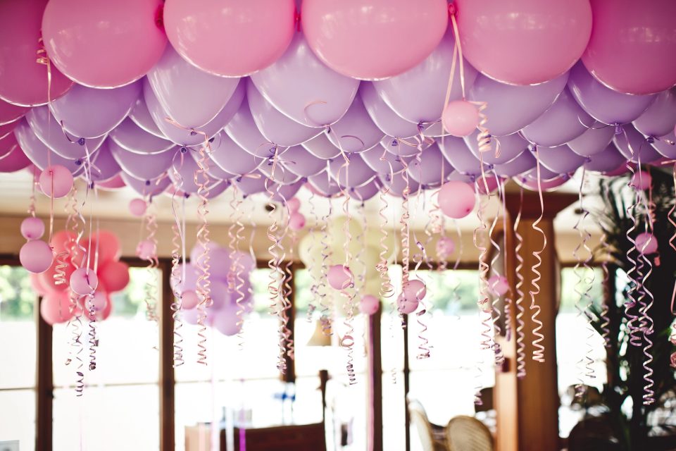 Pink and purple tuftex balloons with ribbons used in elegant event decor