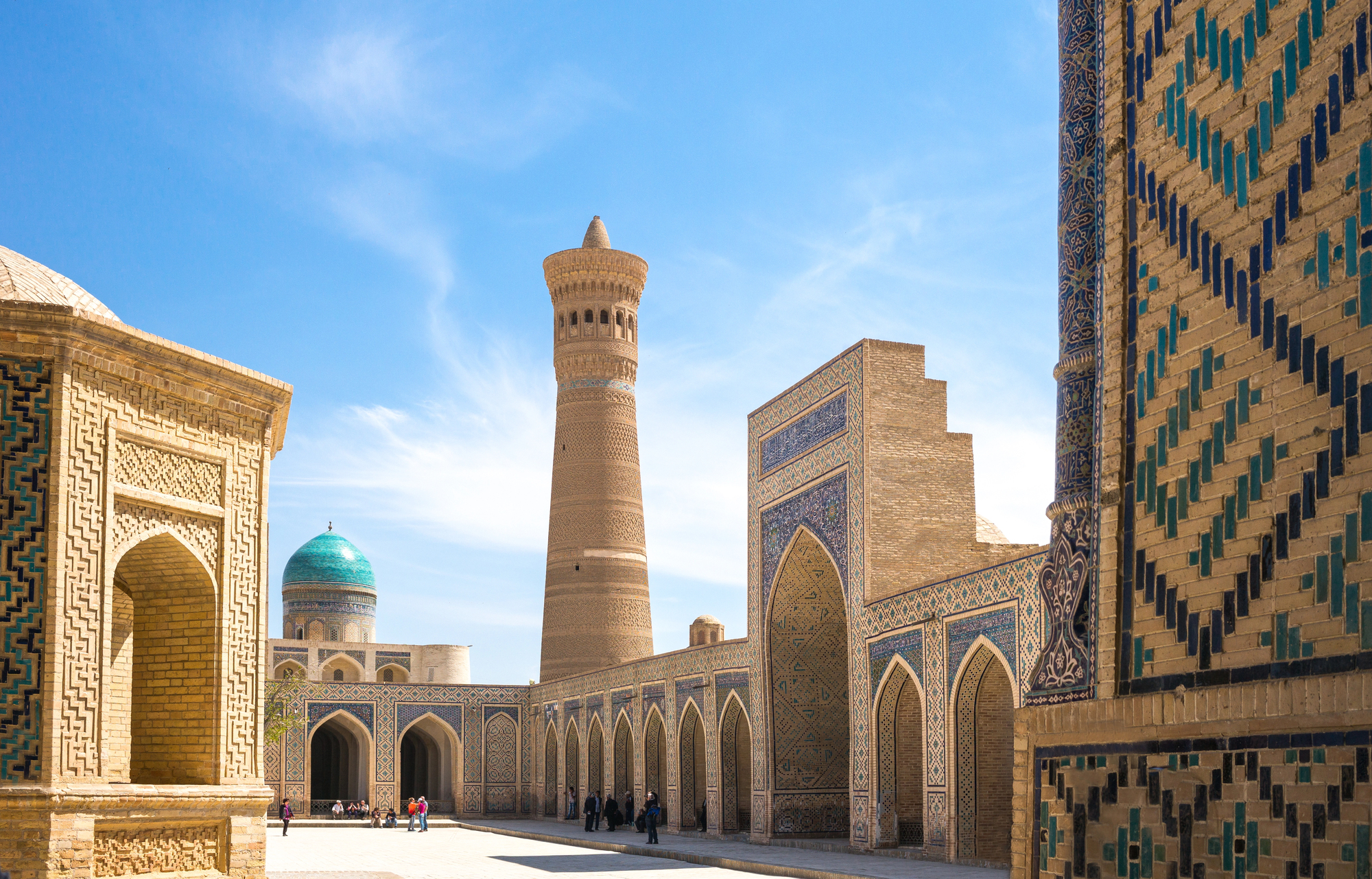Family travel in central asia: educational aspects, cultural exchange, and safety for families with children Historic islamic architecture in bukhara, uzbekistan, featuring intricate mosaic tiles and a central minaret under a blue sky — popular destination on central asia tours for family travel.