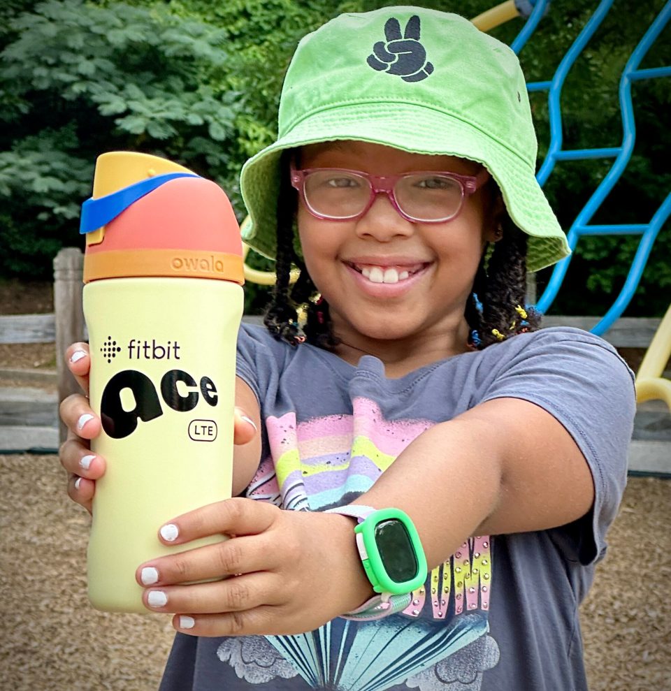 Back-to-school: why smart tech is a lifeline for black parents Smiling black girl showing fitbit ace lte smartwatch for back-to-school tech safety - back-to-school: why smart tech is a lifeline for black parents