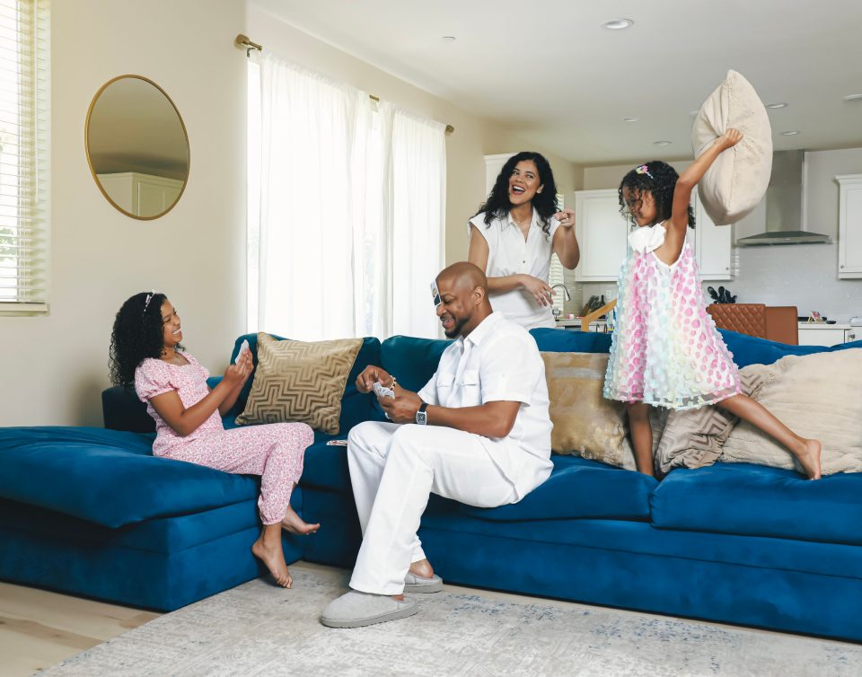 Dad jokes on deck: finesse mitchell’s best role yet Finesse mitchell sits on a blue couch playing cards with his eldest daughter elle kate to his left, while his wife adris debarge smiles behind and their younger daughter eva kristian raises a pillow overhead.