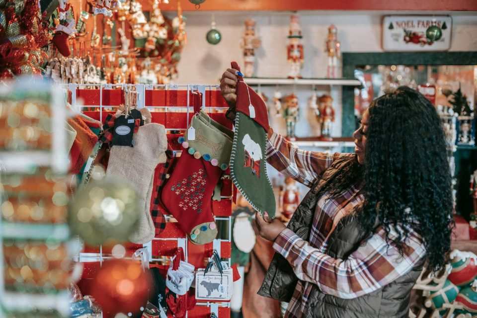 Holiday experience photo by any lane: https://www. Pexels. Com/photo/smiling-black-woman-choosing-christmas-decorations-in-store-5728308/