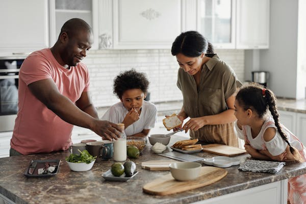 Empowering black parents to advocate for their children’s healthcare An african american family eating healthy for an article on children's healthcare
