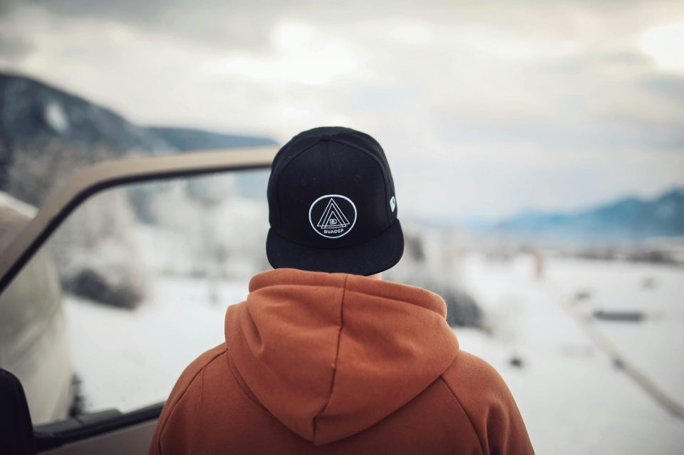 A teenager stares at the landscape wearing a hoodie for an article about hoodie designs for black teens