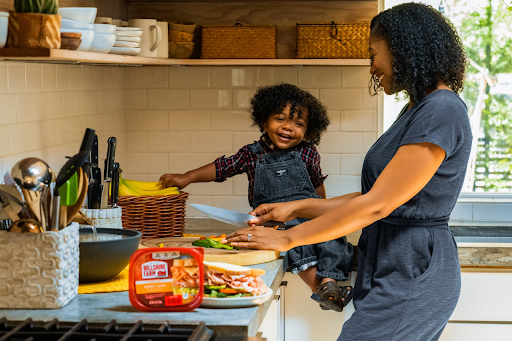 Ideas to make your kitchen more child-friendly African american mother and child making sandwiches at the kitchen counter to make the kitchen more child-friendly