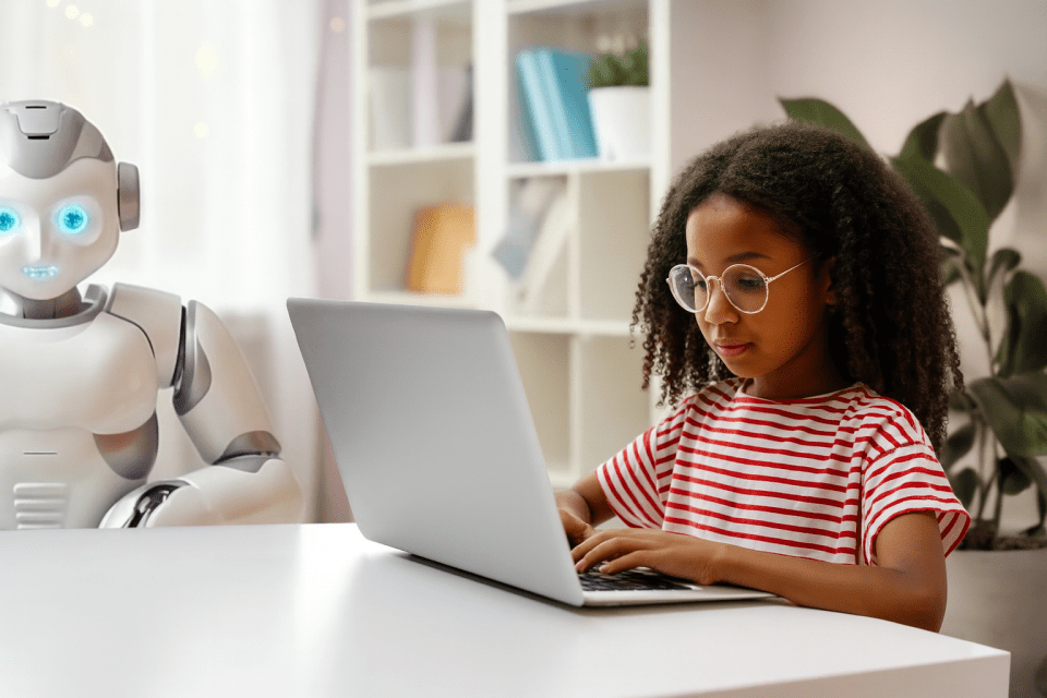 Ai tools are talking to your kids – and collecting their data Young black girl on a laptop next to a humanoid robot, representing kids using ai tools and the need for data collection awareness.