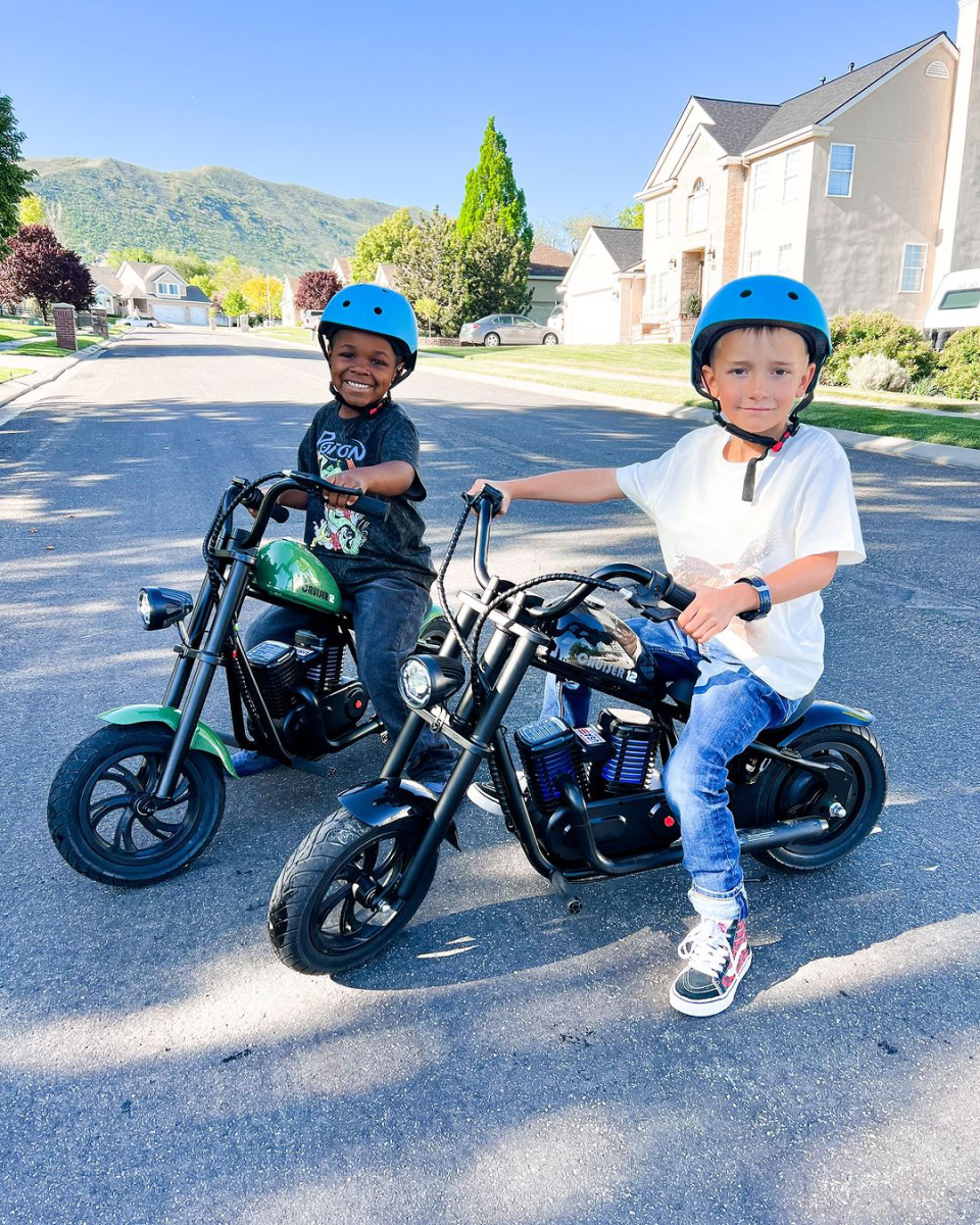 Embrace the outdoors this summer: a guide for parents Two little boys riding a motor cycle. Once is african american boy embrace the outdoors.